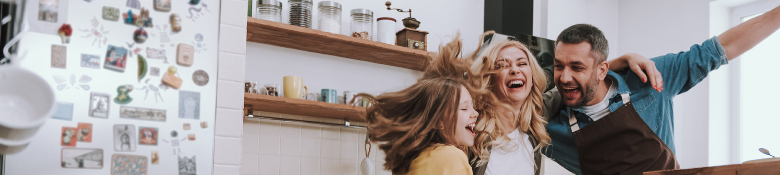 Family dancing in kitchen