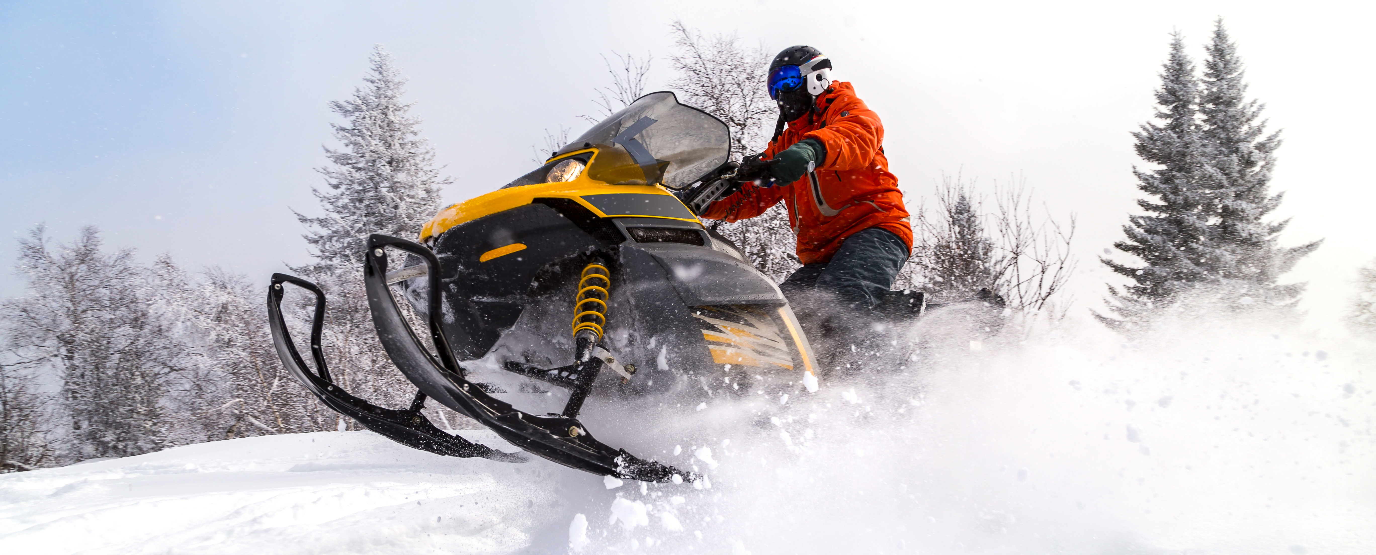 A person is enjoying riding their snowmobile thanks to a snowmobile loan.